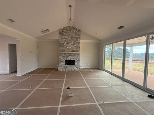 an empty room with a empty space and windows