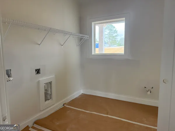 a room with water heater and a cabinet