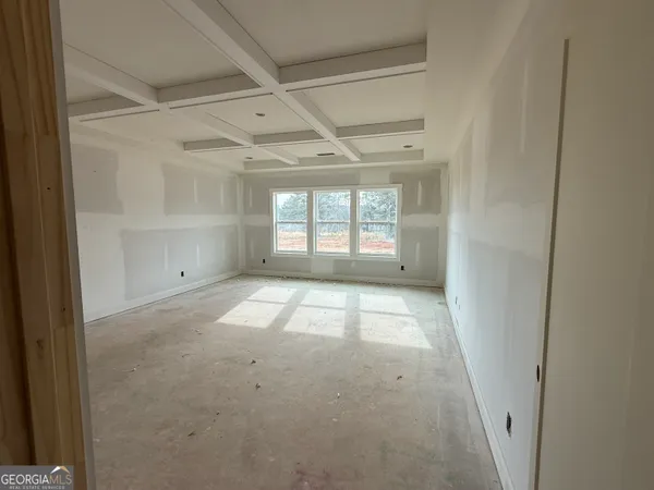 a view of a room with wooden floor and windows