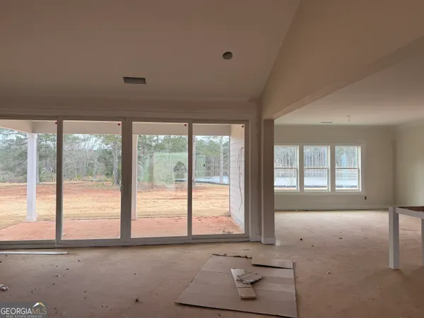 a view of a room with wooden floor and white walls