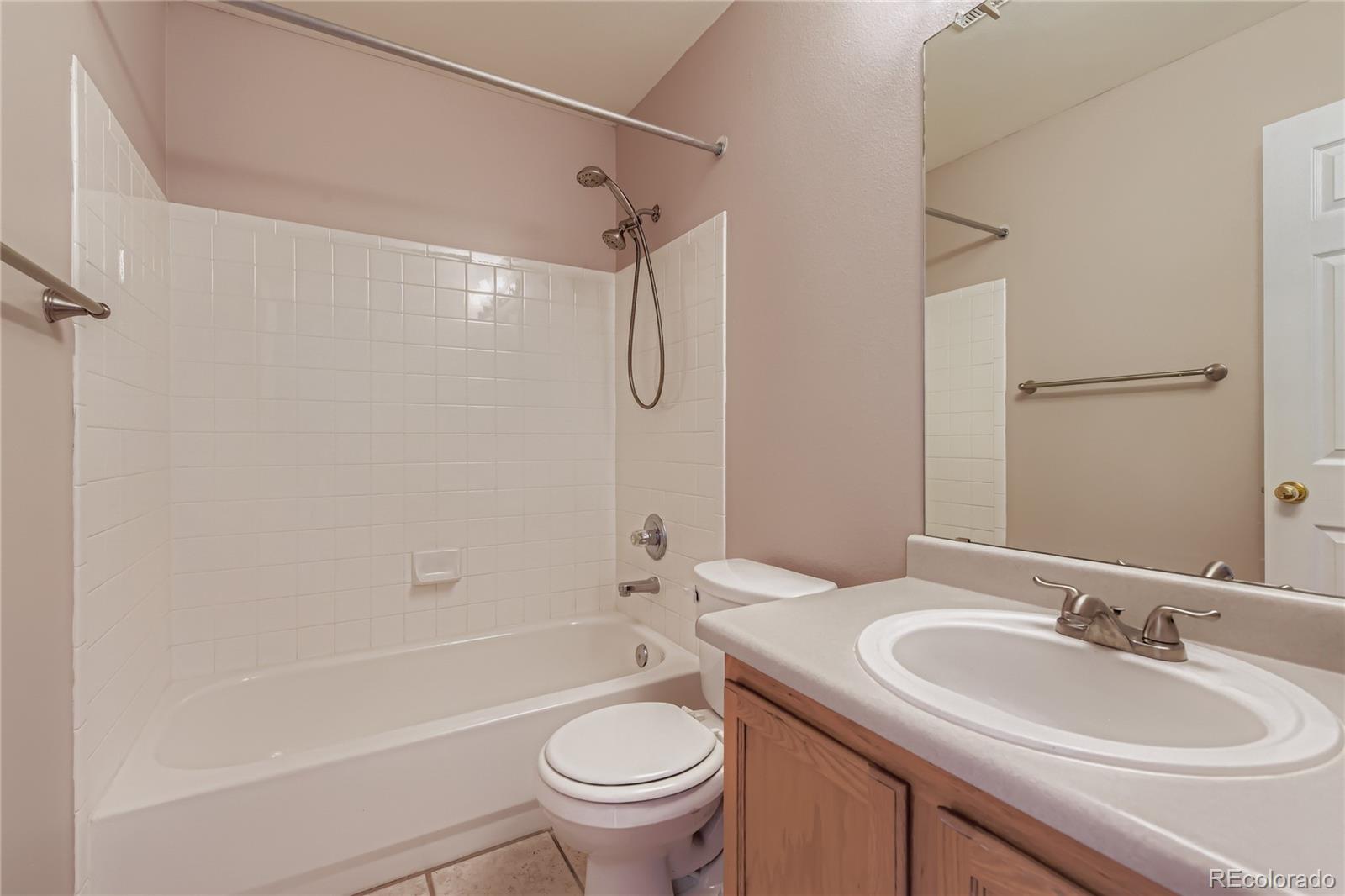 4927 Tarcoola Lane Highlands Ranch, CO 80130 - Photo 13 of 20 a bathroom with a sink a toilet and a bathtub