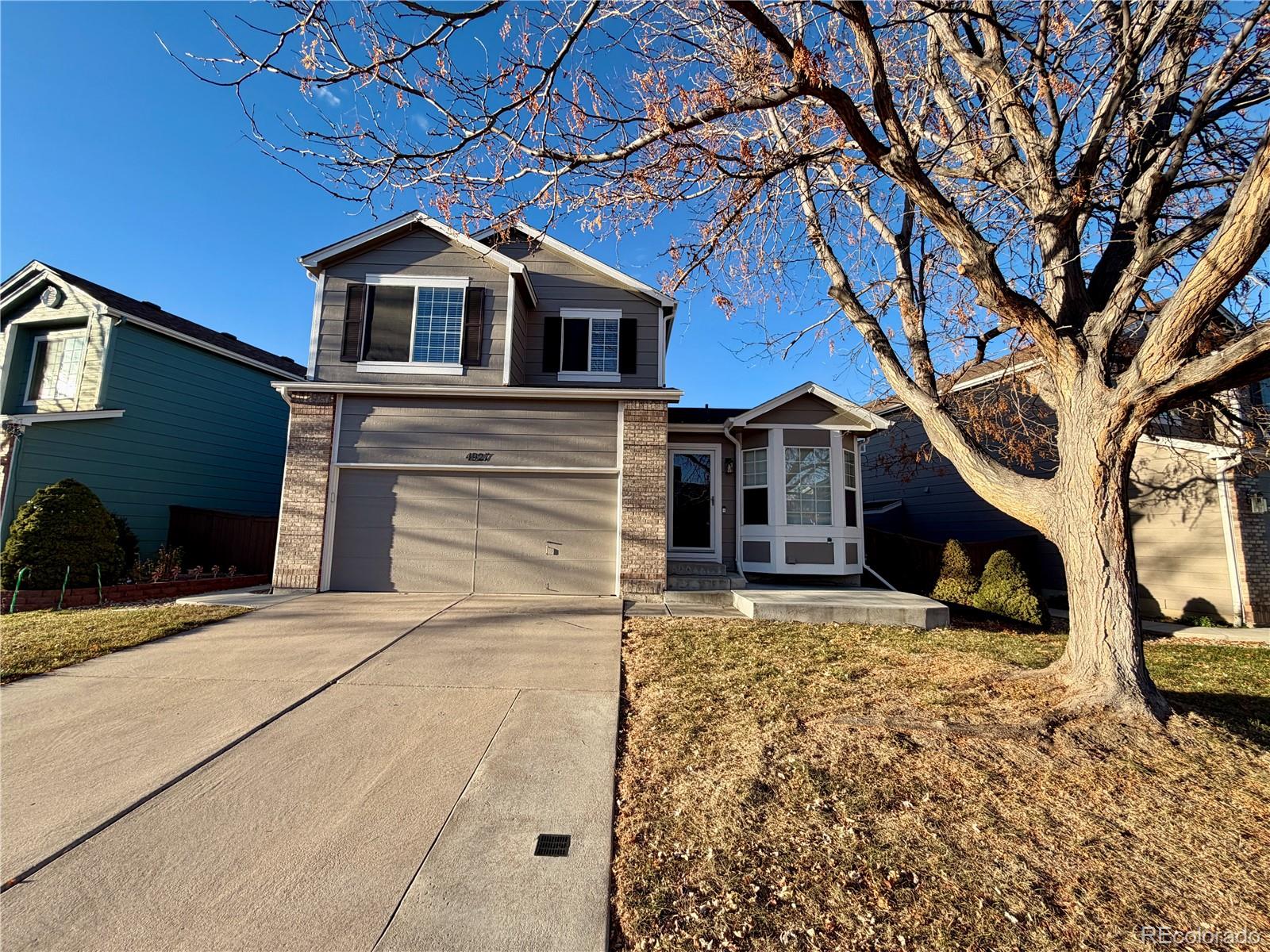 4927 Tarcoola Lane Highlands Ranch, CO 80130 - Photo 2 of 20 a front view of a house with a yard