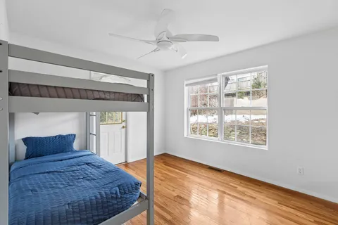 a bedroom with a large bed and a window