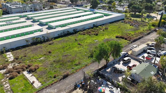 a view of swimming pool with lawn chairs and plants