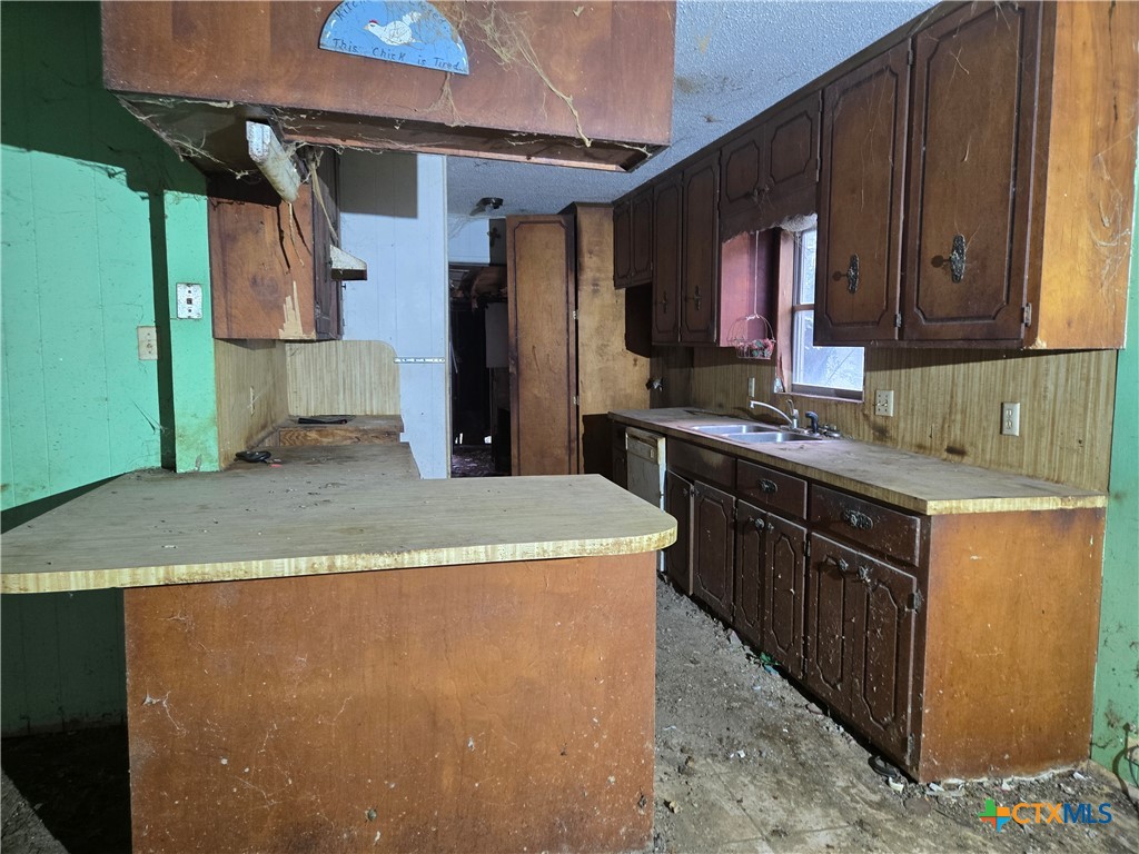 1807 North Wheeler Street Victoria, TX 77901 - Photo 2 of 3 a kitchen with stainless steel appliances granite countertop a sink stove and refrigerator