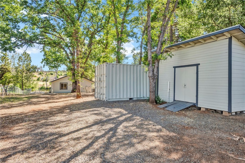 16410 Tish-A-Tang Road Lower Lake, CA 95457 - Photo 26 of 48 a view of a house with a yard and garage