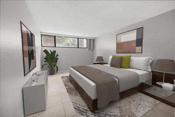 a bedroom with bed and a potted plant on dresser