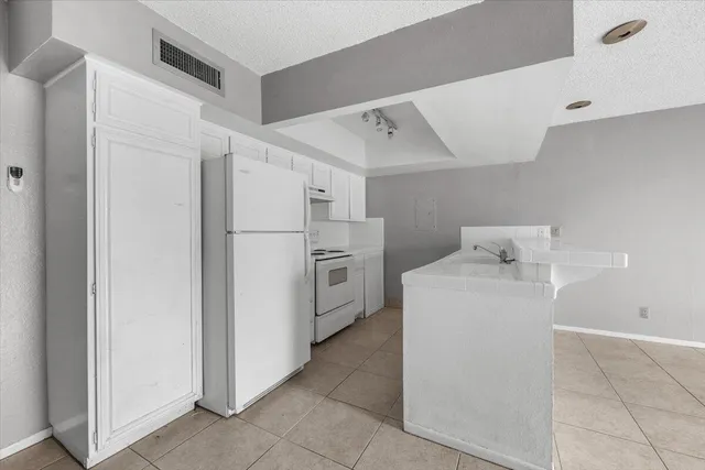 a utility room with cabinets washer and dryer