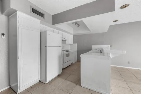 a utility room with cabinets washer and dryer
