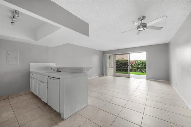 a view of a kitchen with furniture and natural light