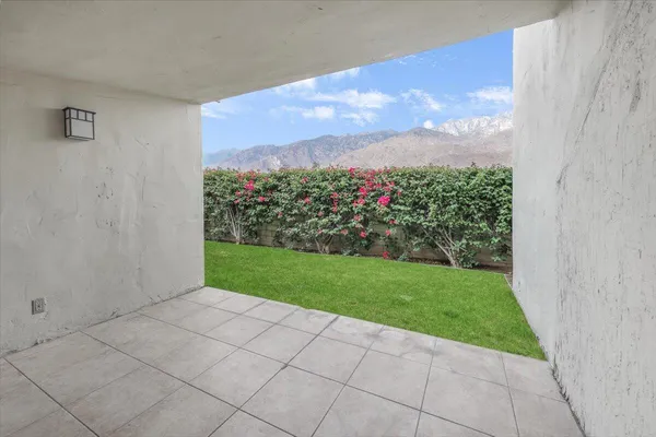 a view of a back yard from a corridor
