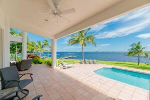 901 Southeast Riverside Drive Stuart, FL 34994 - Photo 26 of 53 a view of a swimming pool with a lounge chairs