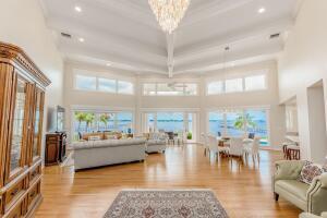 901 Southeast Riverside Drive Stuart, FL 34994 - Photo 32 of 53 a living room with furniture and a chandelier
