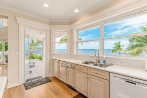 901 Southeast Riverside Drive Stuart, FL 34994 - Photo 38 of 53 a bathroom with a granite countertop sink and a window