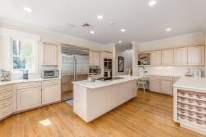 901 Southeast Riverside Drive Stuart, FL 34994 - Photo 39 of 53 a large white kitchen with kitchen island a sink white cabinets and stainless steel appliances