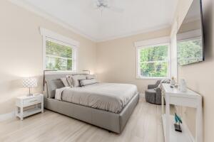 901 Southeast Riverside Drive Stuart, FL 34994 - Photo 40 of 53 a bedroom with a bed and a window