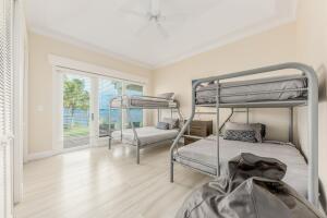 901 Southeast Riverside Drive Stuart, FL 34994 - Photo 44 of 53 a bedroom with furniture and a window