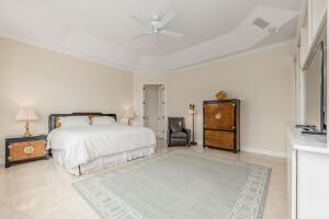 901 Southeast Riverside Drive Stuart, FL 34994 - Photo 50 of 53 a bedroom with a bed and ceiling fan
