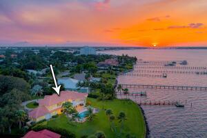 901 Southeast Riverside Drive Stuart, FL 34994 - Photo 5 of 53 a view of a garden with a building in the background