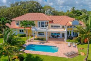 901 Southeast Riverside Drive Stuart, FL 34994 - Photo 6 of 53 a front view of a house with garden