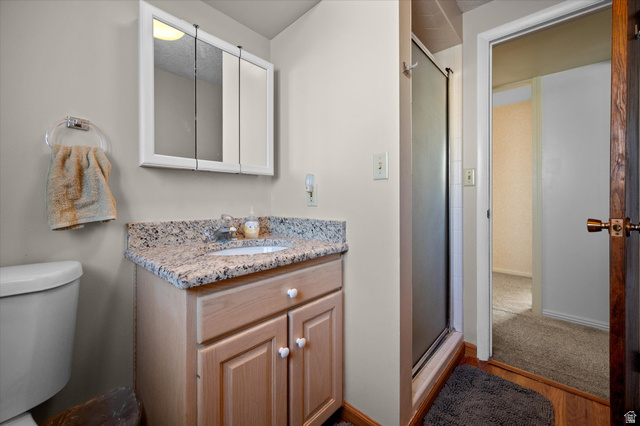 2298 West 800 North Clinton, UT 84015 - Photo 32 of 53 Bathroom with a shower stall, vanity, and light wood-type flooring