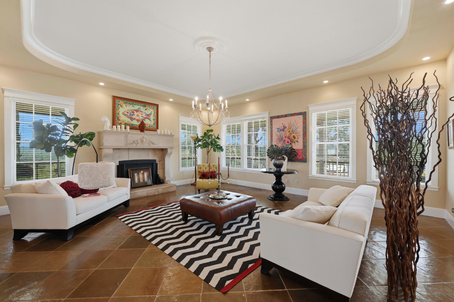 10120 Shenandoah Road Plymouth, CA 95669 - Photo 26 of 86 a living room with furniture a chandelier and a fireplace
