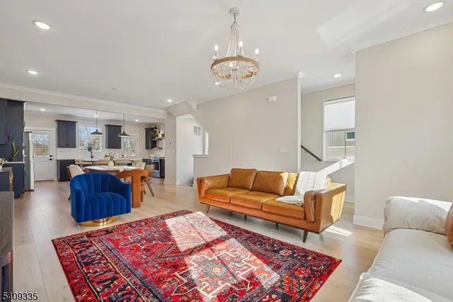 a living room with furniture and kitchen view