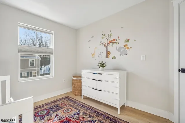 a room with painting on the wall and a potted plant