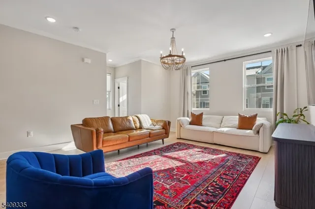 a living room with furniture and a chandelier
