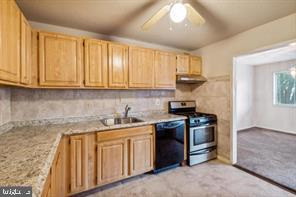 1836 Metzerott Road, Unit 222 Hyattsville, MD 20783 - Photo 8 of 16 a kitchen with stainless steel appliances granite countertop a stove a sink and a microwave