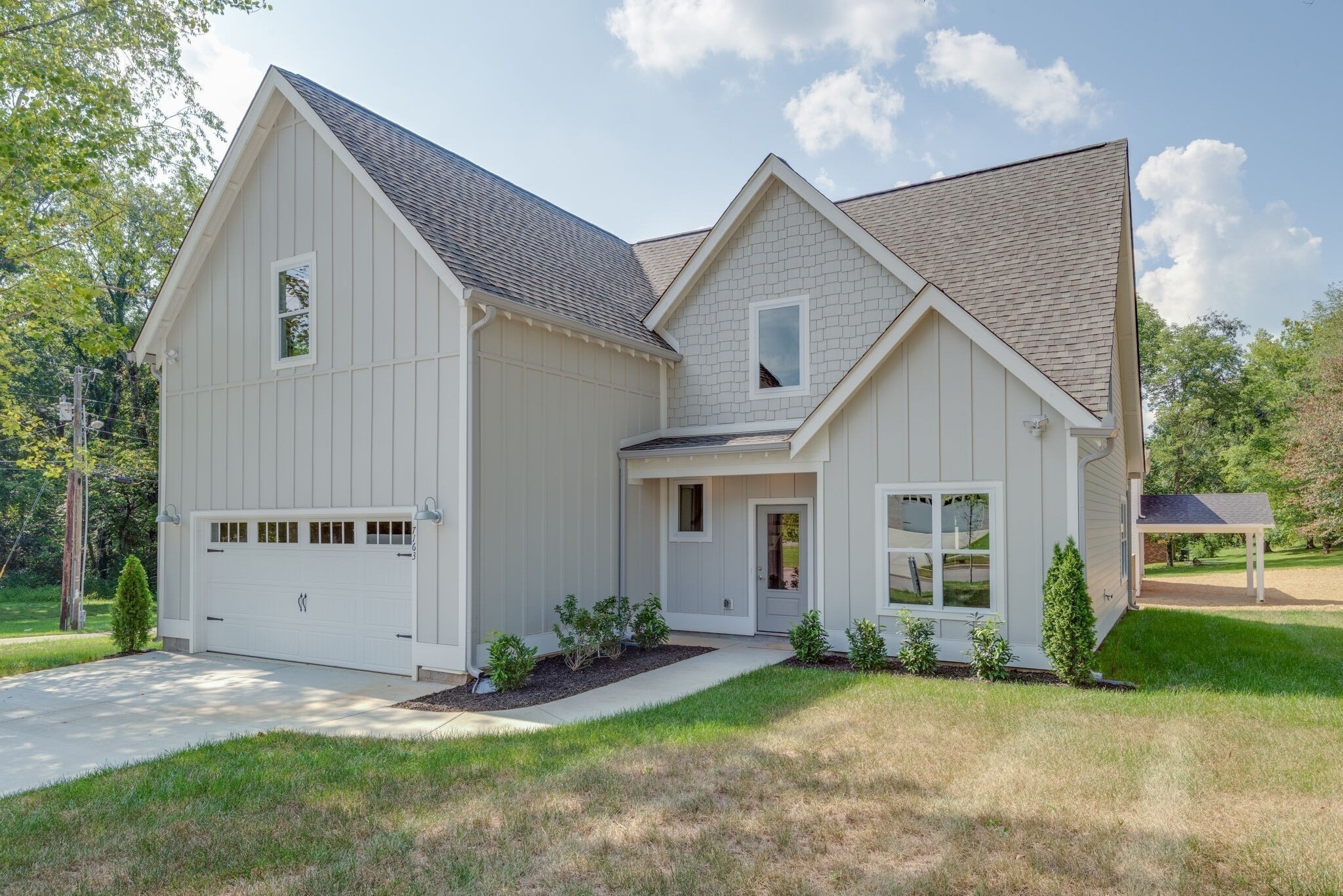 7163 Pepper Tree Circle Fairview, TN 37062 - Photo 3 of 30 a view of a yard in front of a house with plants and large tree