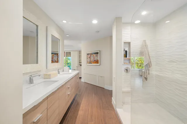 a bathroom with a granite countertop sink a toilet and a mirror