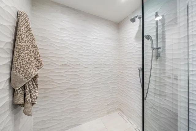 a spacious bedroom with a bed and a large window