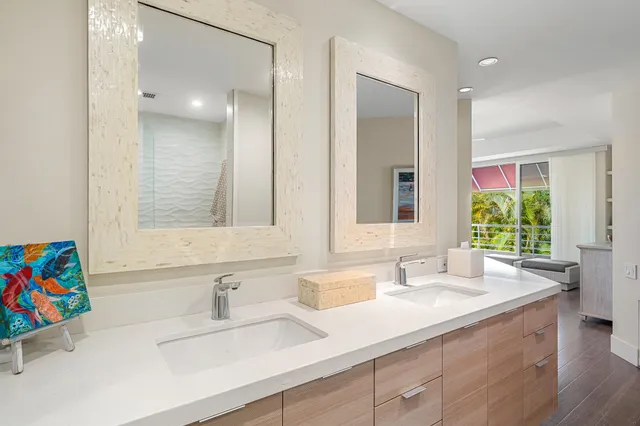 a bedroom with a large bed and large windows