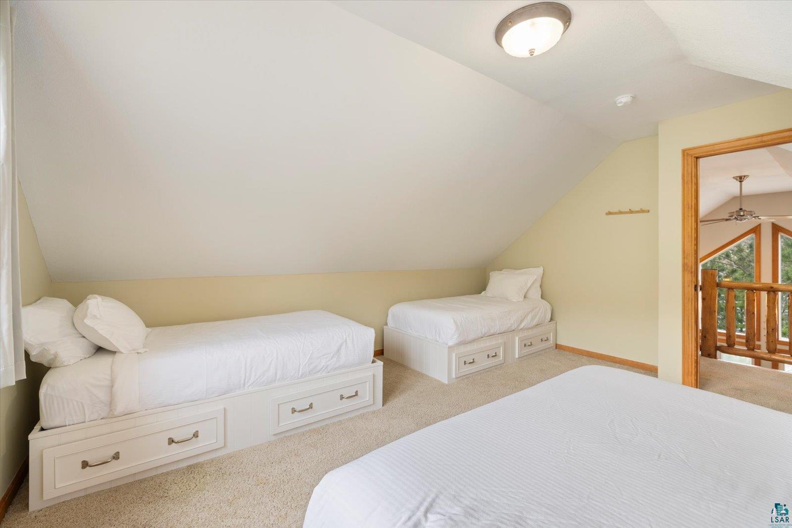 6266 Giants Ridge Road Biwabik, MN 55705 - Photo 20 of 37 Carpeted sleeping area featuring an angled ceiling, recessed wall, and a flush mount ceiling light