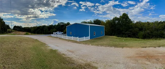 a view of a barn with big yard