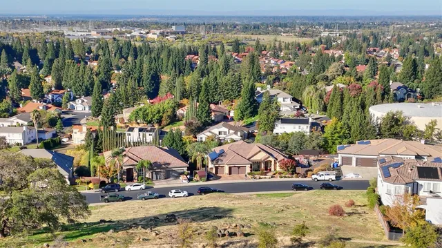an aerial view of residential houses with outdoor space