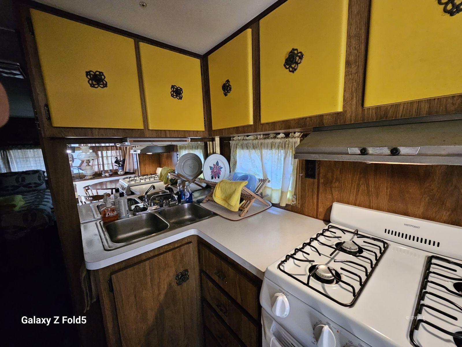 25955 Highway 243, Unit 40 Idyllwild, CA 92549 - Photo 11 of 32 a kitchen with stainless steel appliances a stove a sink and cabinets