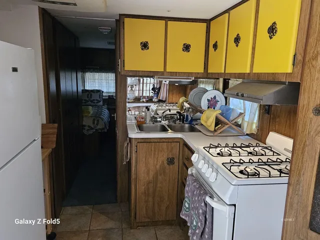 a kitchen with stove and refrigerator