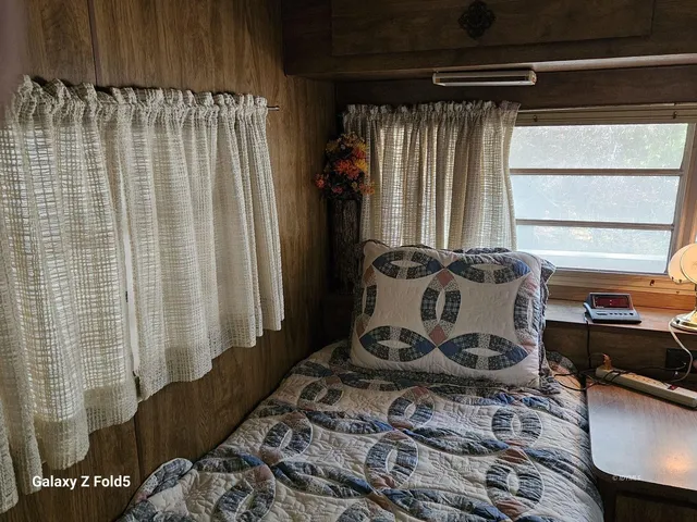 a view of a bed and a dresser