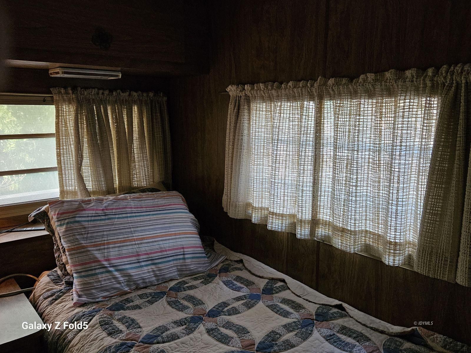 25955 Highway 243, Unit 40 Idyllwild, CA 92549 - Photo 16 of 32 a bedroom with a bed and a window