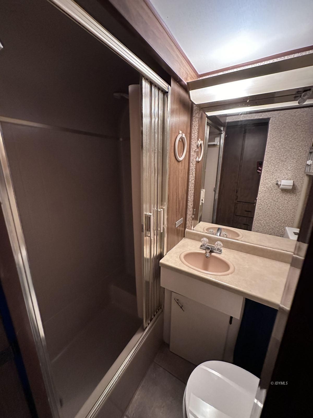 25955 Highway 243, Unit 40 Idyllwild, CA 92549 - Photo 22 of 32 a bathroom with a sink a toilet a mirror and shower