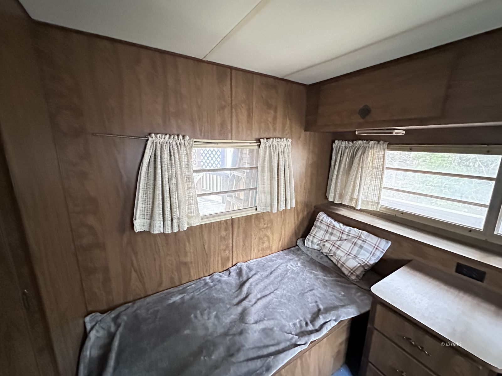 25955 Highway 243, Unit 40 Idyllwild, CA 92549 - Photo 25 of 32 a bed sitting in a bedroom next to a window