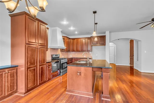 a kitchen with a sink appliances and cabinets