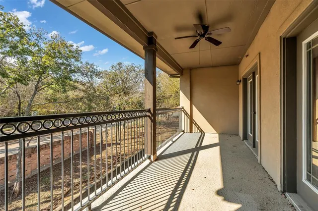 a view of an empty room with windows and closet
