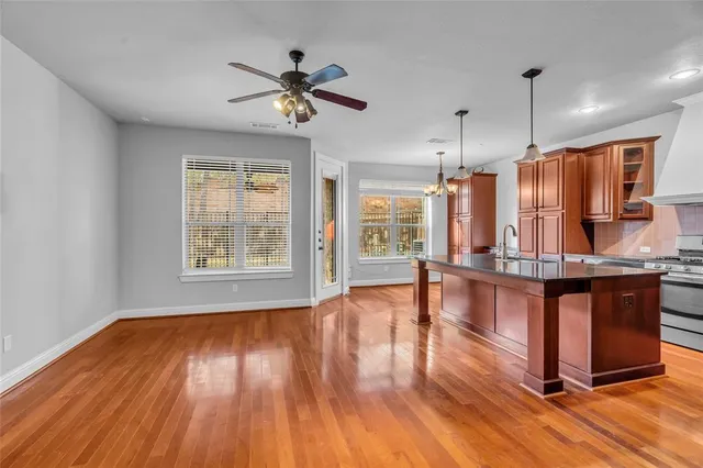 a view of a room with wooden floor and window