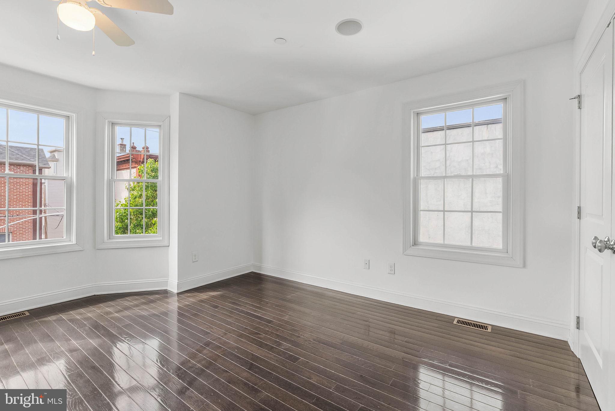 1015 North 3rd Street, Unit H Philadelphia, PA 19123 - Photo 17 of 27 an empty room with wooden floor and windows