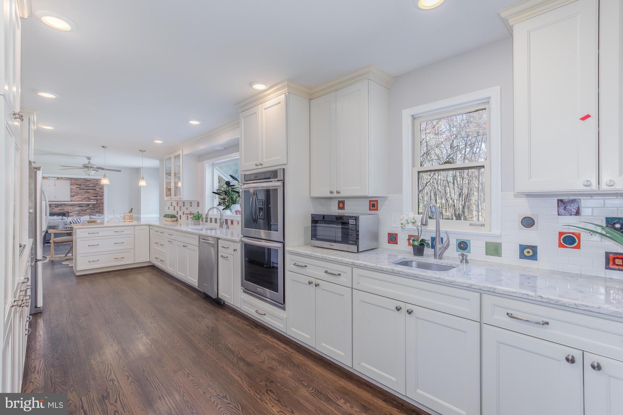 16217 Whitehaven Road Silver Spring, MD 20906 - Photo 11 of 50 a kitchen with white cabinets and white appliances
