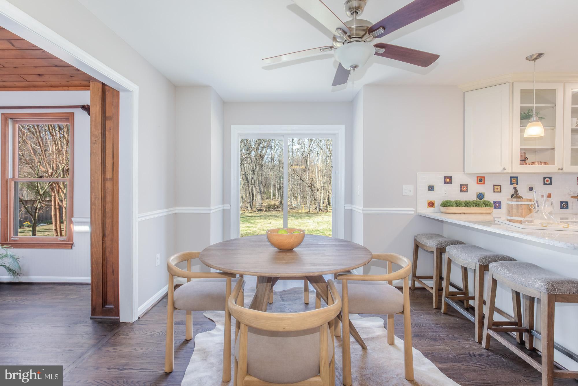 16217 Whitehaven Road Silver Spring, MD 20906 - Photo 16 of 50 a view of a dining room with furniture window and wooden floor