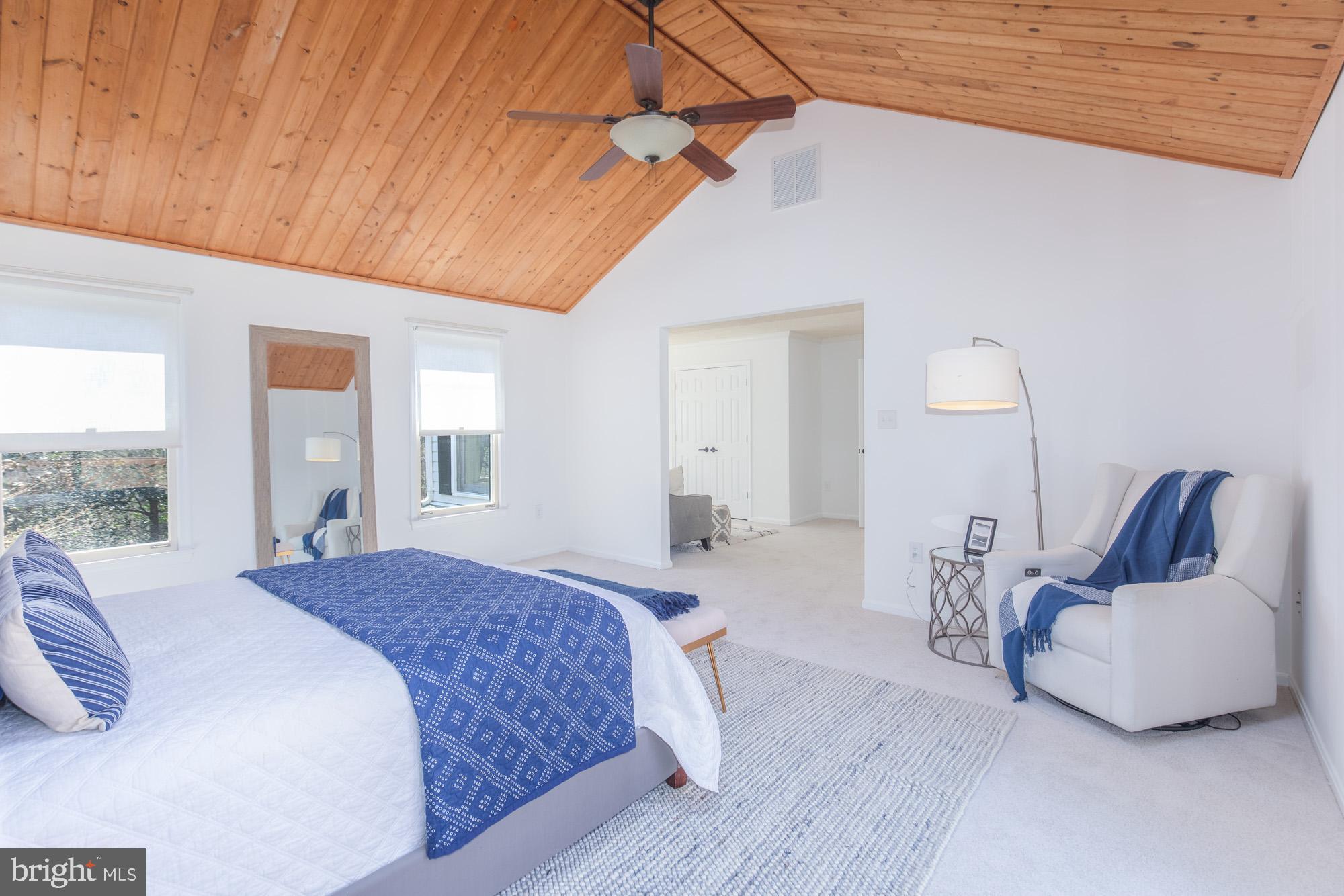 16217 Whitehaven Road Silver Spring, MD 20906 - Photo 30 of 50 a bedroom with a bed and lamp